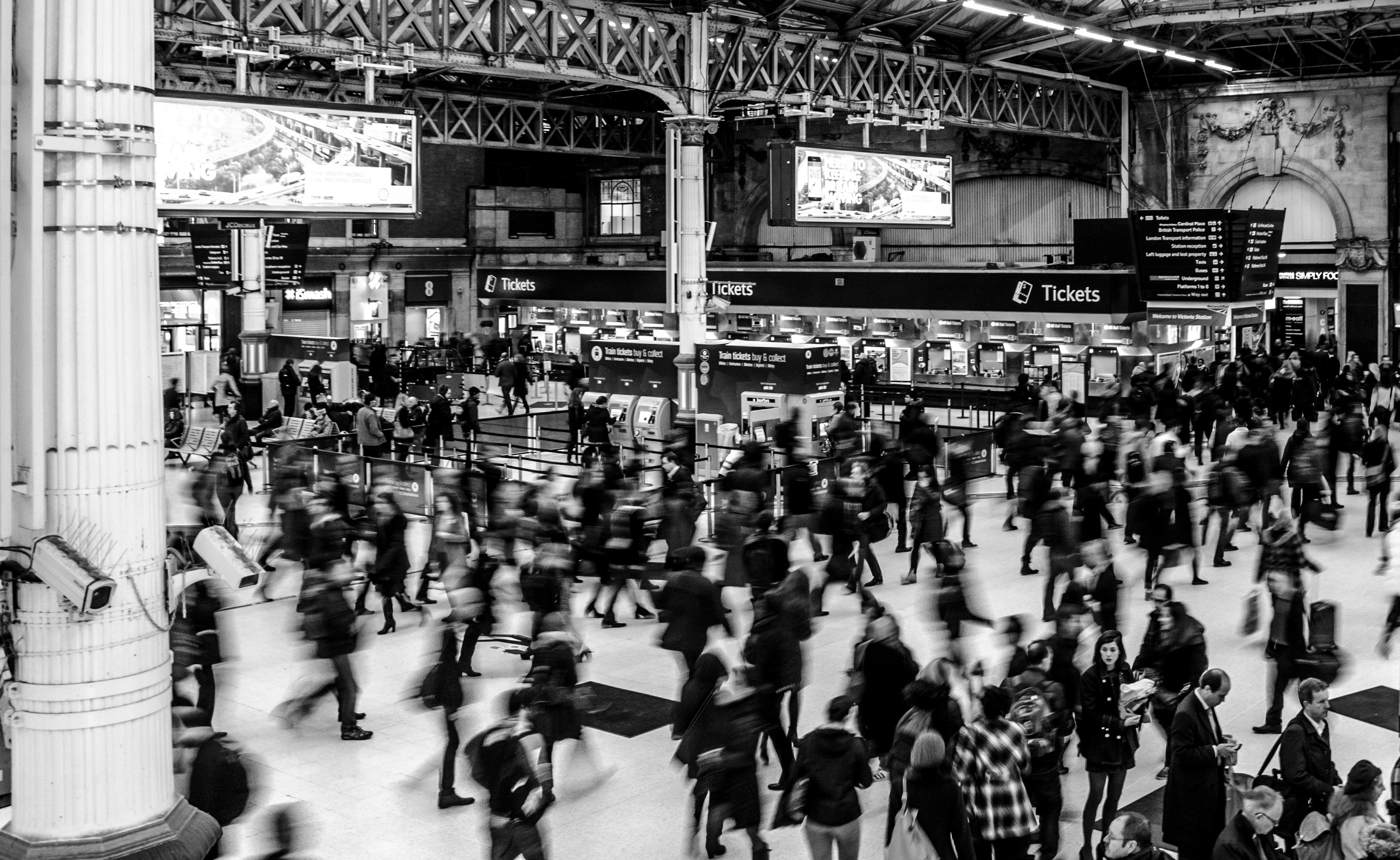 grayscale-photography-of-people-walking-in-train-station-735795