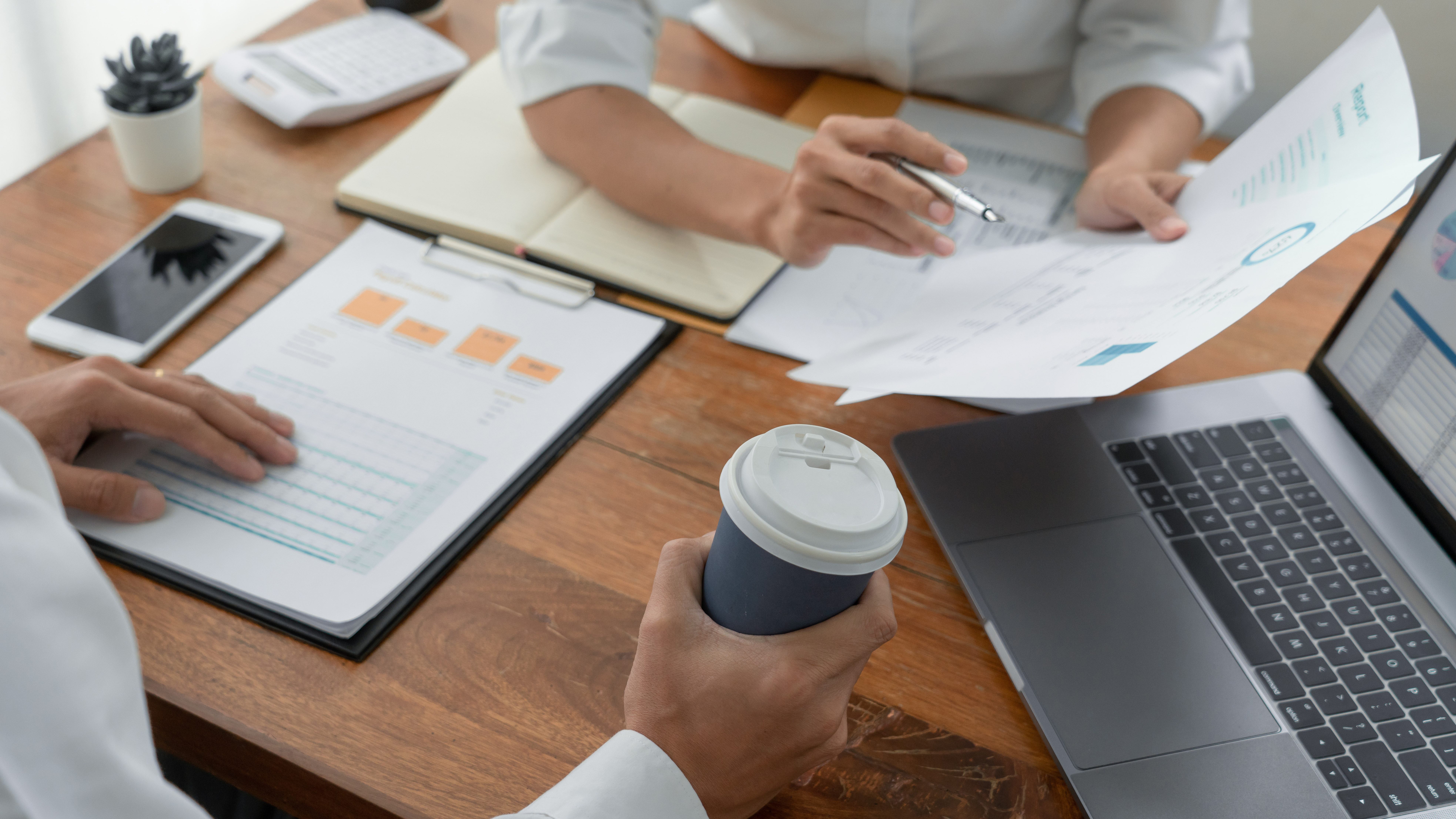 Business People Talking Discussing with coworker planning analyzing financial document data charts and graphs in Meeting and successful teamwork Concept.